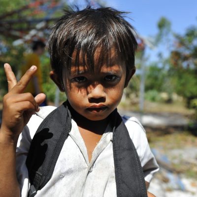 A boy at Otres Primary School stands for a photo Dec. 16, 2011, as U.S. Sailors and Marines participate in a community service project at the school in Sihanoukville, Cambodia. Sailors with amphibious dock landing ship USS Pearl Harbor (LSD 52) and amphibious transport dock ship USS New Orleans (LPD 18) and Marines with the 11th Marine Expeditionary Unit participated in the event while on a deployment in the U.S. 7th Fleet area of responsibility as part of the Makin Island Amphibious Ready Group. (U.S. Navy photo by Mass Communication Specialist 2nd Class Jason Behnke/Released)